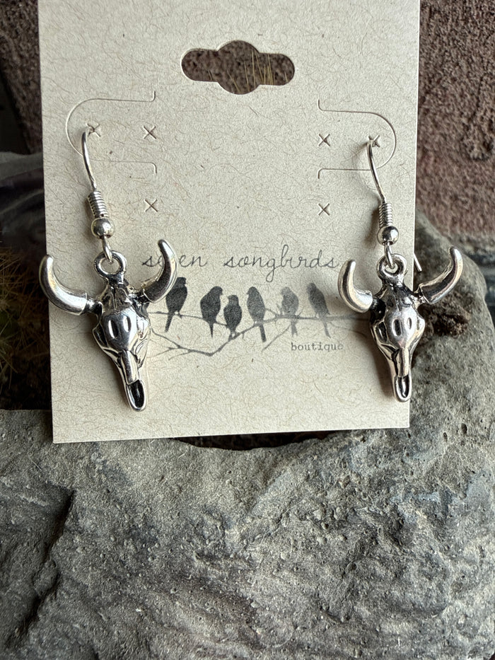 Silver-tone cow skull charm fishhook earrings, two-piece pair with dangling skulls.