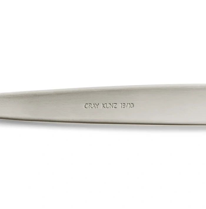 Silver JB Prince Gray Kunz Sauce Spoon in Original size showcasing Gray Kunz Logo 18/10 on underside of spoon.