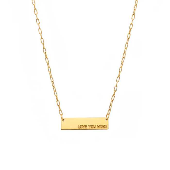 Love You More Plaque Necklace (Gold) | Love You More featuring a delicate gold chain with a rectangular plaque engraved with the words "LOVE YOU MORE" for a simple, elegant look.