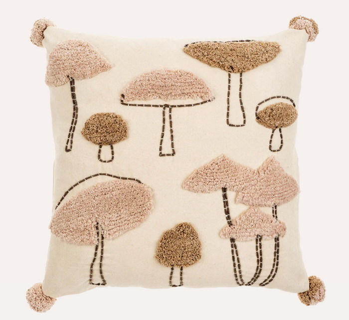 Decorative pillow with tufted mushroom pattern on a beige background