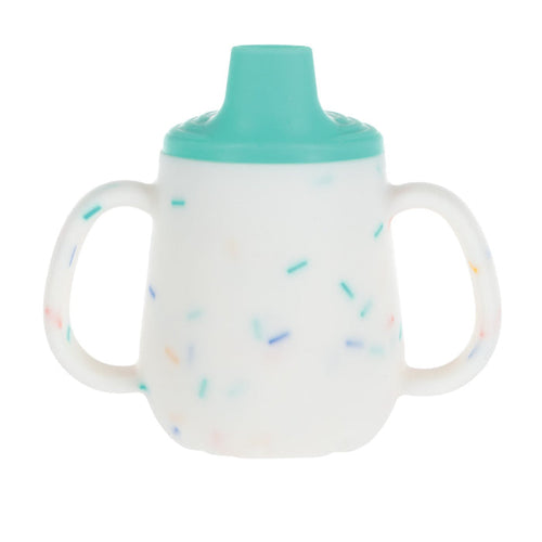 The Nuby US 3-Stage Training Cup Set with Handles | Confetti features a white silicone cup with colorful speckles, teal lid, and two handles, shown against a plain white background.