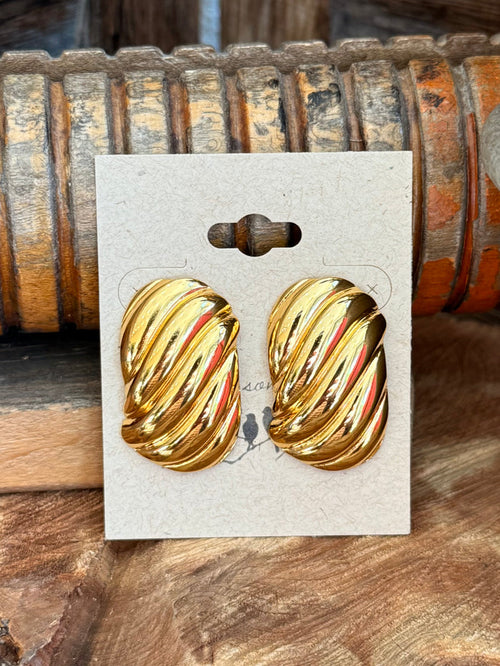 Gold-plated textured oval stud earrings close-up, pair