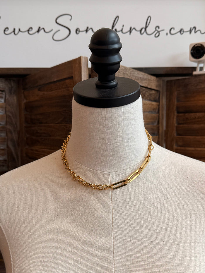 Gold plated chain necklace with alternating big and small links, on a bust display