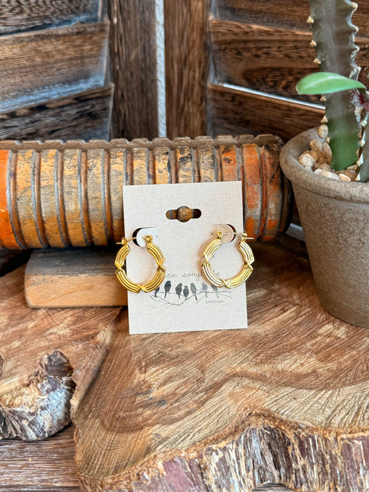 Gold-plated textured wire hoop earrings, shown on display card