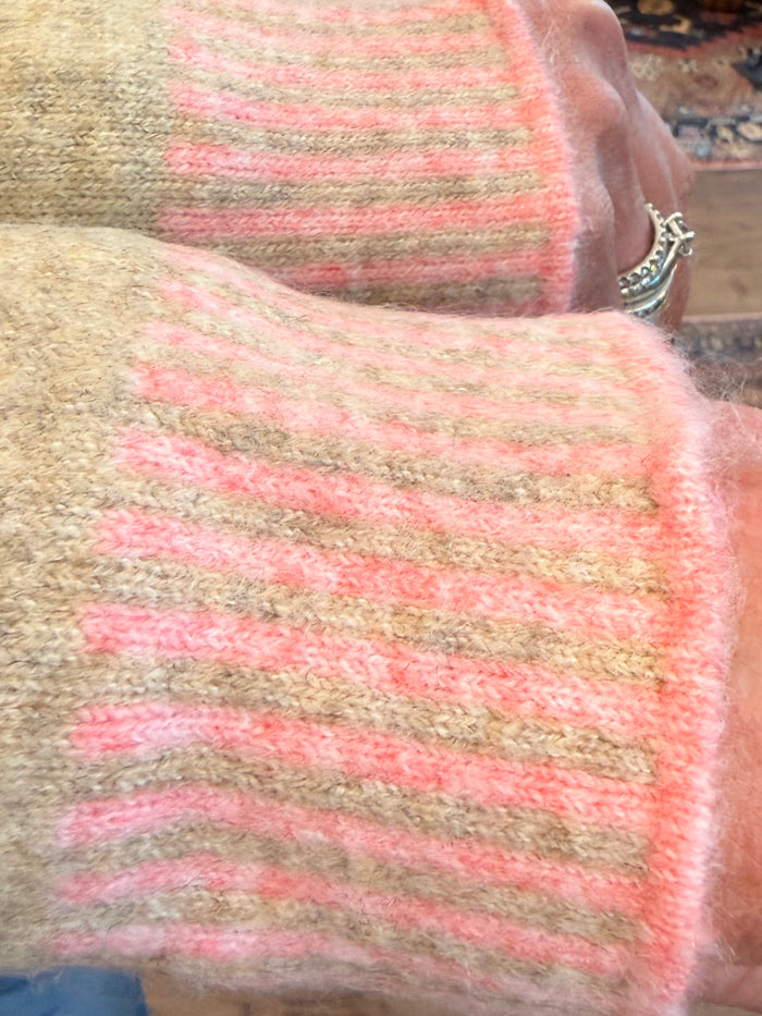 Beige knit mockneck sweater with pink stripe pattern detail.