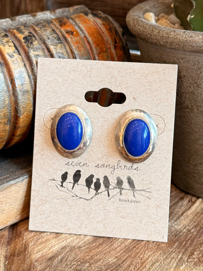 Blue oval lapis stud earrings, gold-tone bezel with butterfly backs on display card
