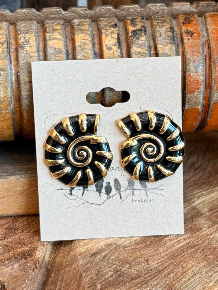 Black and gold shell stud earrings on display card, spiral swirl center