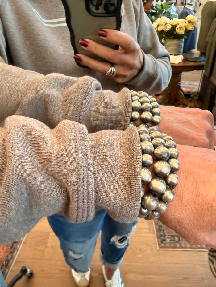 Heather brown hooded sweatshirt sleeve cuff and knit hem detail, with kangaroo pocket