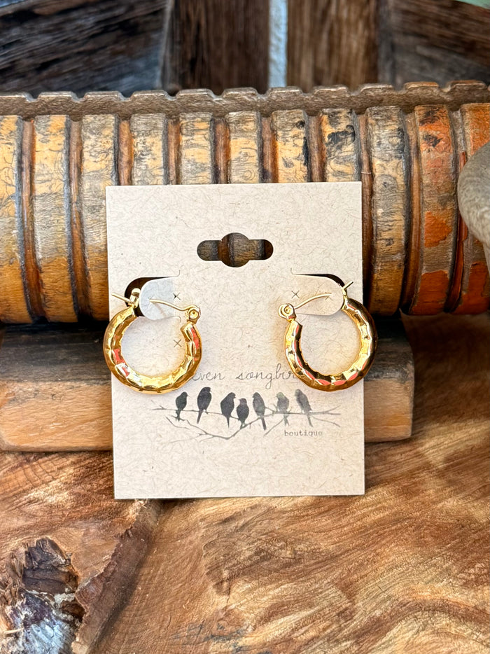 Gold-plated crescent stud earrings with textured curved hoops, visible backs