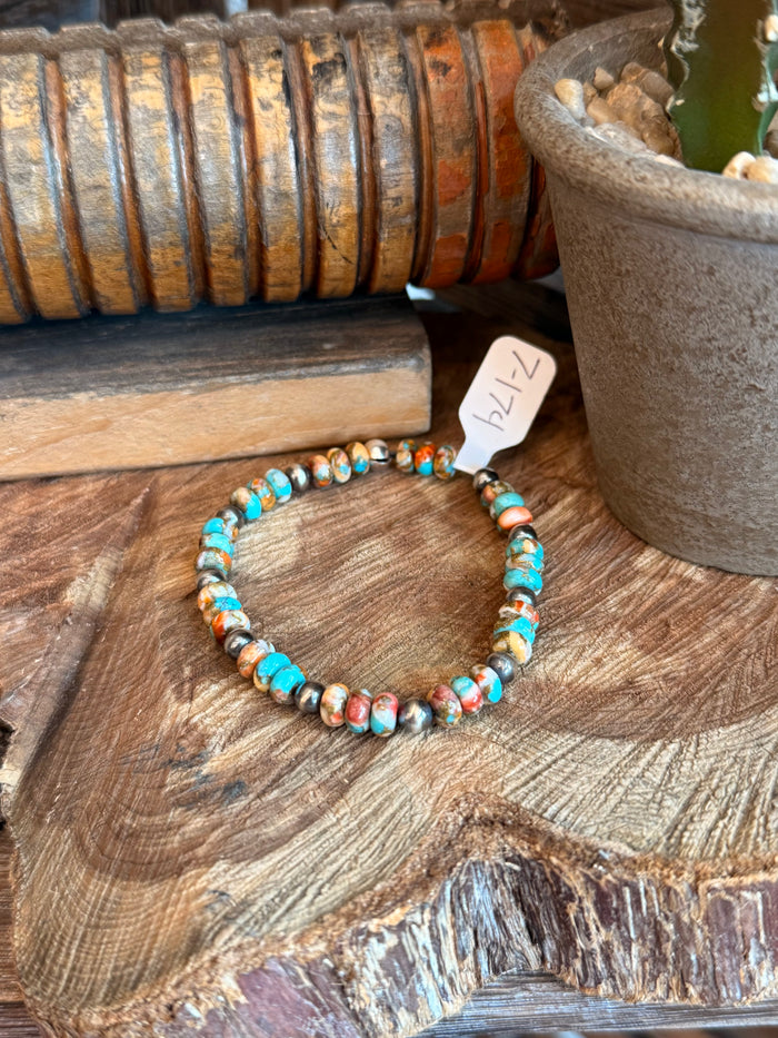 Turquoise and orange bead stretch bracelet with small silver pearl accents, 7-inch