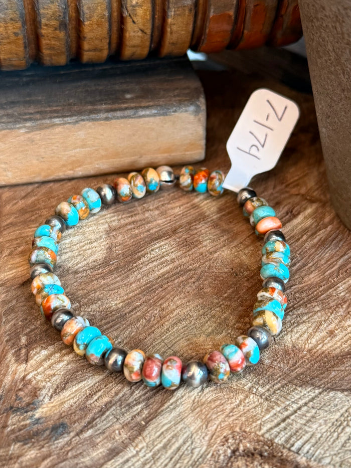 Multi-color turquoise, orange, and red bead stretch bracelet with silver pearl details