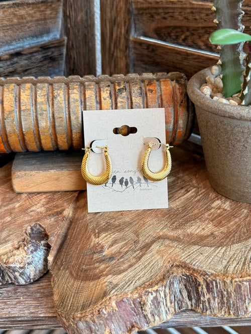 Gold-tone textured half-hoop earrings with hinged clasp backs