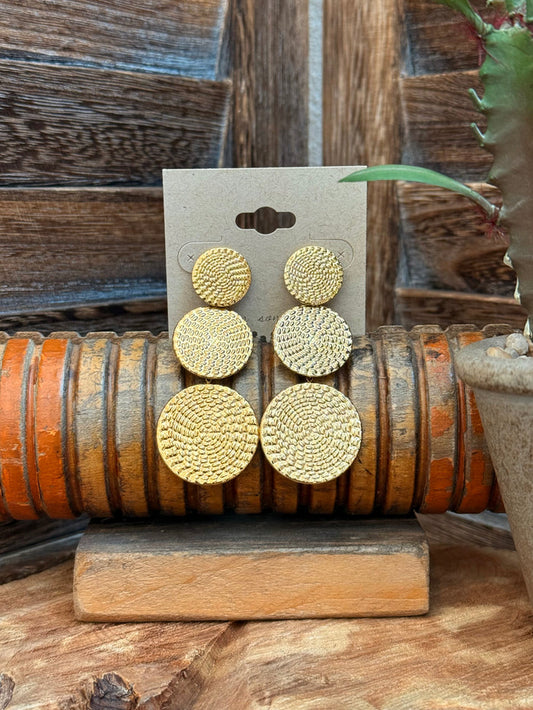 Triple round textured gold-tone stud earrings on a card, three stacked circles per pair