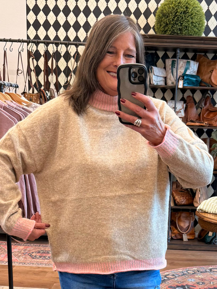 Beige pink striped mockneck sweater with ribbed cuffs and hem, long sleeves.