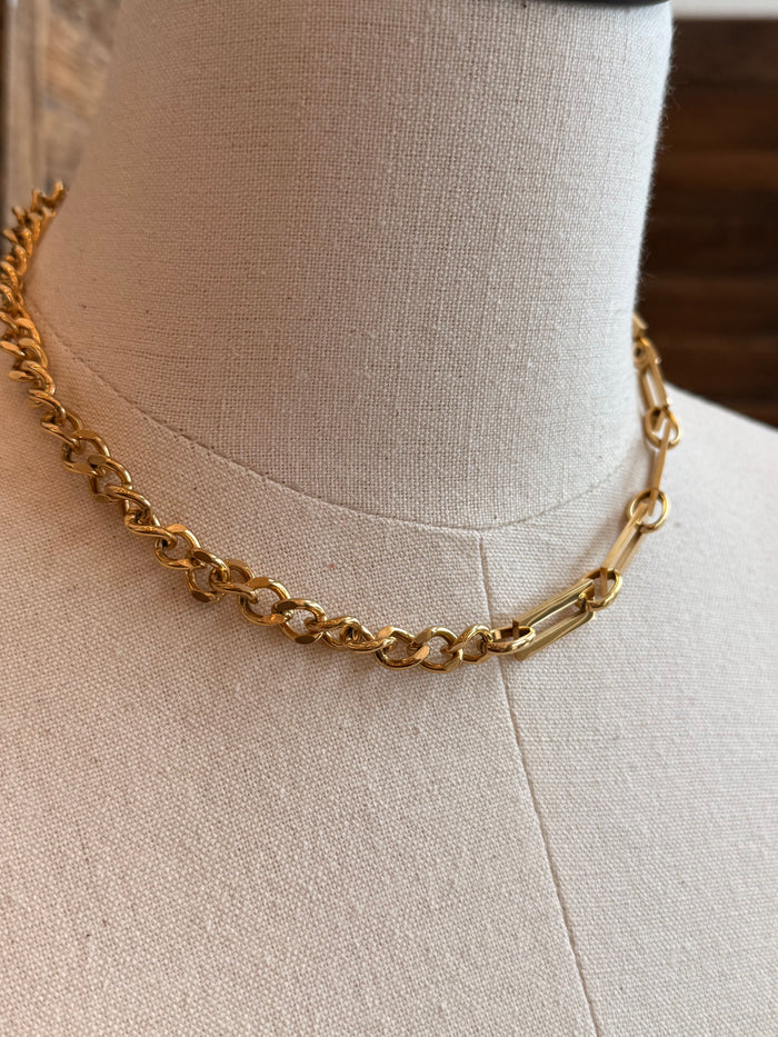 Gold plated chain necklace with alternating big and small links, close-up