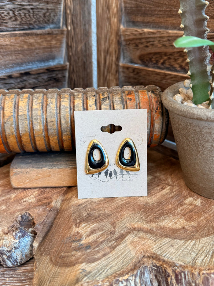 Gold-tone stud earrings with dark blue teardrop stones and black edges
