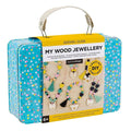 Wooden jewellery craft kit packaging with colorful polka dot design on a beige background