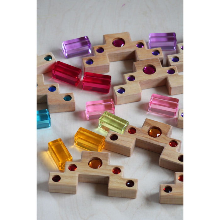 Colorful wooden blocks with embedded beads on a light background