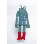 Crocheted toy frog with a polka dot diaper on a white background