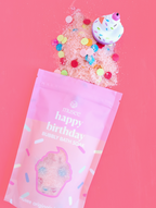 Happy Birthday bubble bath with packaging on a pink background