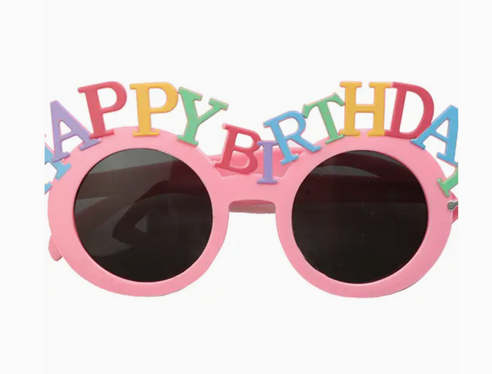 Pink sunglasses with 'Happy Birthday' text on a white background