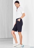 Woman wearing Bizcare Womens Comfort Waist Cargo Short CL957LS in white with sneakers