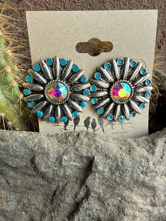 Silver-tone starburst stud earrings with turquoise stones and iridescent center blooms
