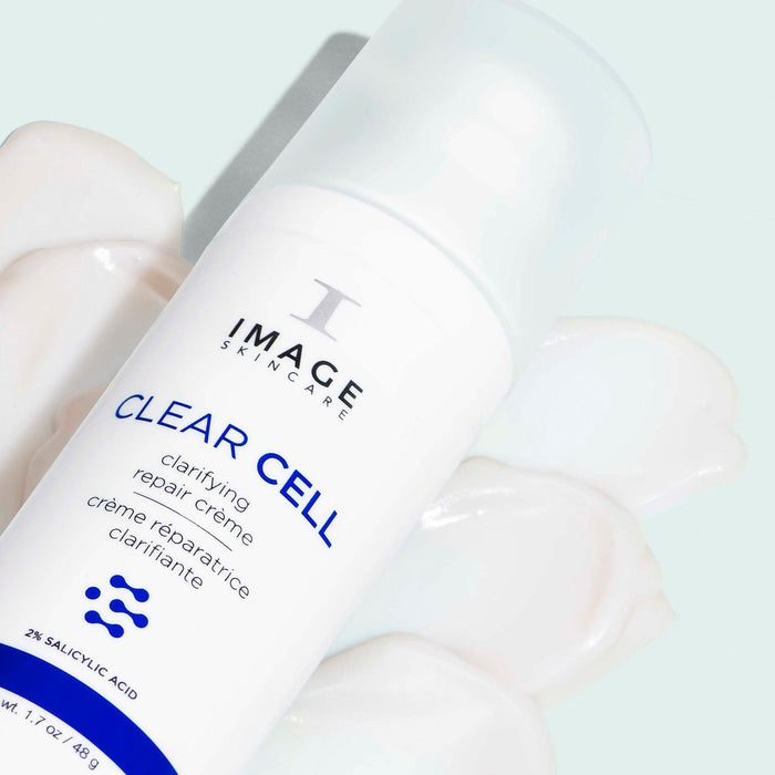 CLEAR CELL clarifying repair crème | IMAGE Skincare bottle on a light background with white cream swatches, showcasing skincare product for skin clarity and repair.
