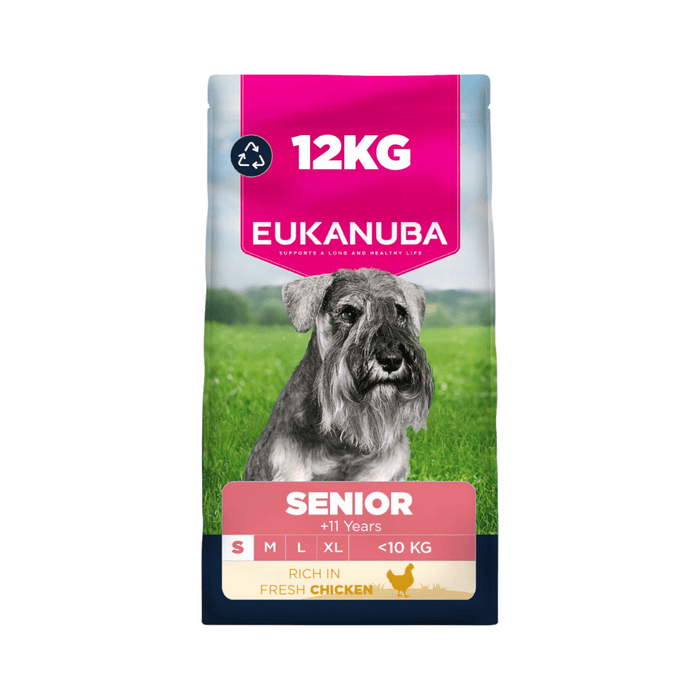 A 12kg bag of Eukanuba Senior dog food, featuring a grey and white schnauzer on a green grassy field. The packaging has a bright pink top section with the brand name 'EUKANUBA' in white, a pink 'SENIOR' label, and a dark navy blue bottom section.