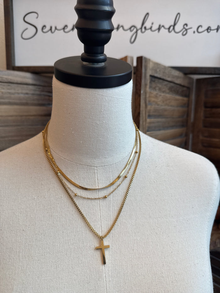 Gold plated triple-layer cross necklace with small cross pendant, layered chain design