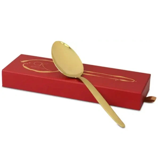 Gray Kunz Spoon Limited Edition in Gold with red box on white background.