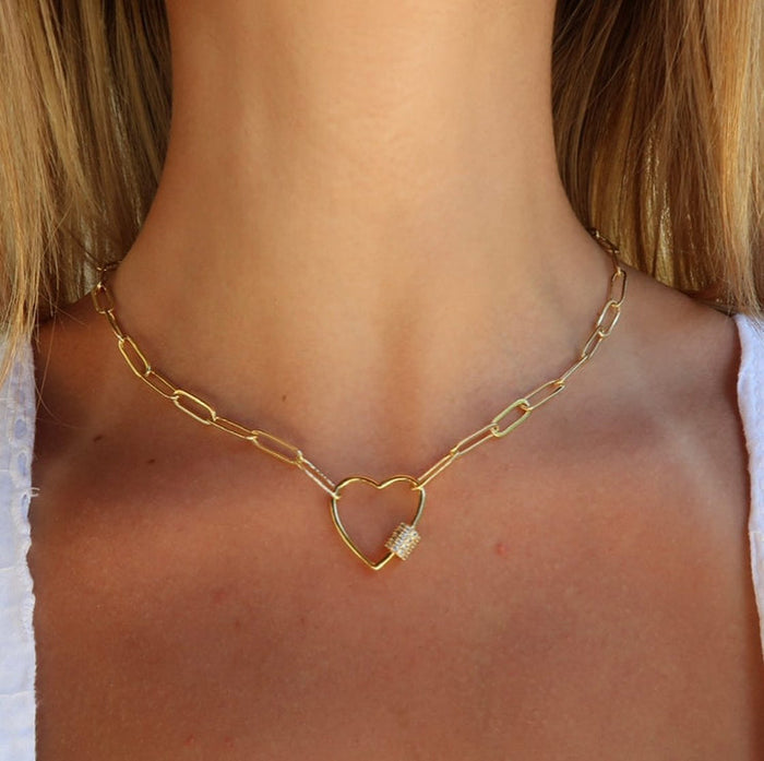Close-up of a woman's neck wearing the Heart Link Gold Paperclip Chain Necklace (18" / White Crystal Studded) | Love You More, featuring a gold paperclip chain with a heart-shaped pendant studded with white crystals.