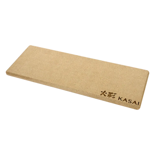 A beige-colored, rectangular heat mat with the brand 'KASAI' written on it, placed on a dark background.