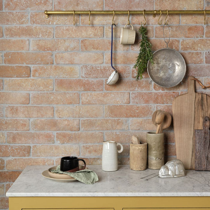 Marble kitchen counter and a terracotta brick wall
