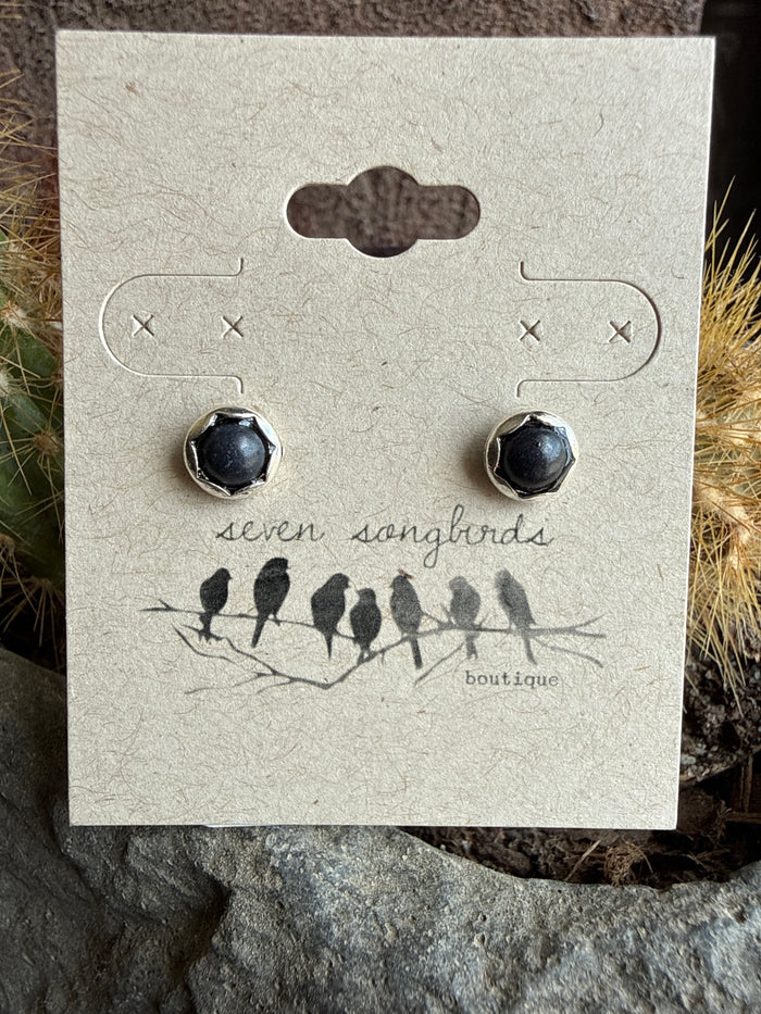 Mini stud earrings with round black stone domes in silver-tone bezels.