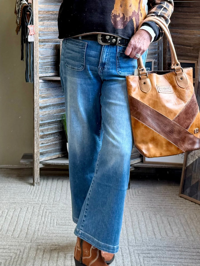 Blue cropped jeans with patch front pockets and dark button closure