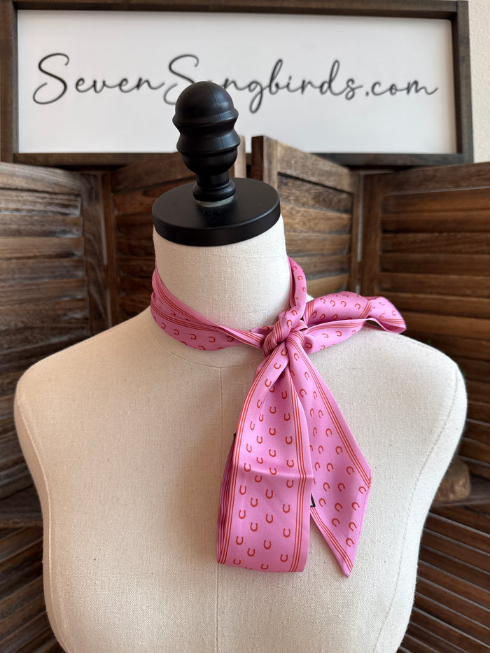 Pink twilly scarf with horseshoe print, tied bow on mannequin neck