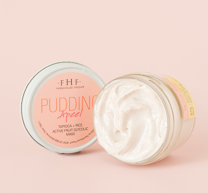 Open jar of Pudding Apeel® Tapioca + Rice Active Fruit Glycolic Mask | FarmHouse Fresh showing creamy white skincare mask with a smooth texture on a soft pink background.
