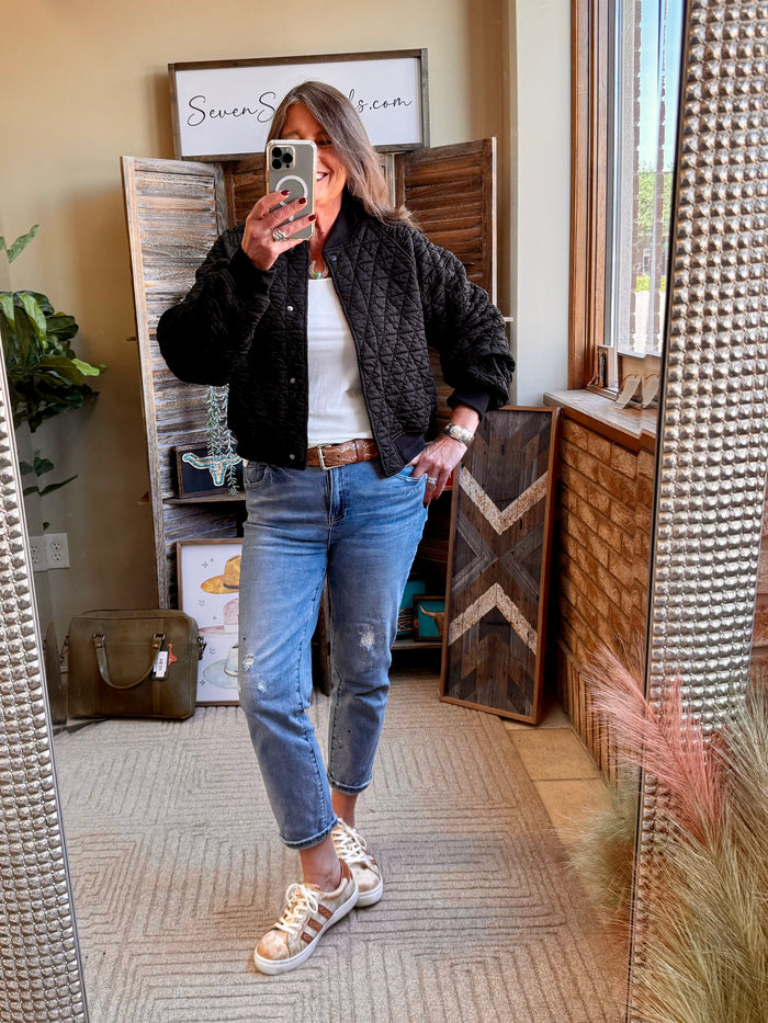 Quilted snap-front bomber jacket in dark black with ribbed cuffs and hem