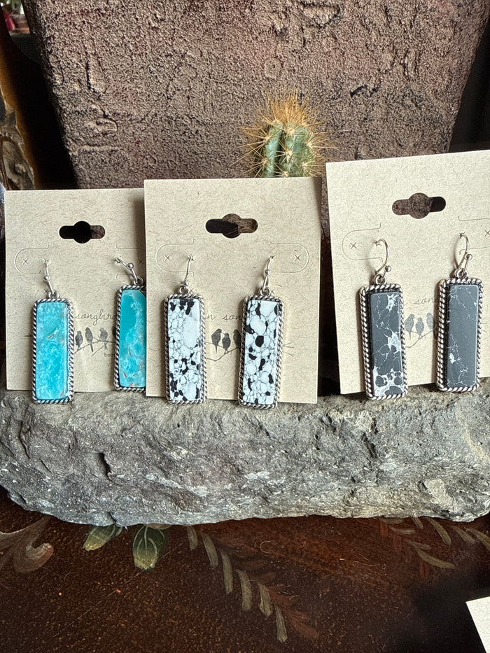 Stone fishhook earrings set with rectangular white, black, and turquoise cabochons
