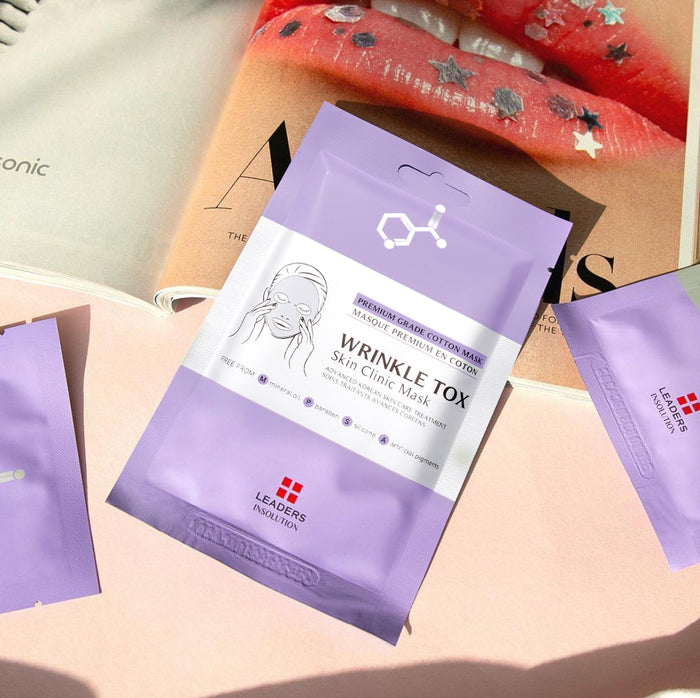 Wrinkle Tox Skin Clinic Mask | Leaders packaged in a pastel lavender sachet, displayed on a soft pink surface with a lifestyle magazine background, promoting skincare wellness.